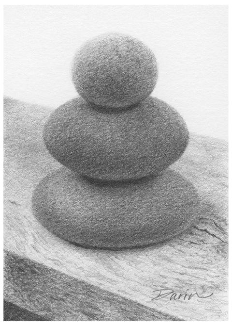 A black and white graphite drawing of three stacked rounded stones, as a cairn, on a wood surface, with a visible artist signature ‘Darin’ near the bottom right, with a narrow white border.