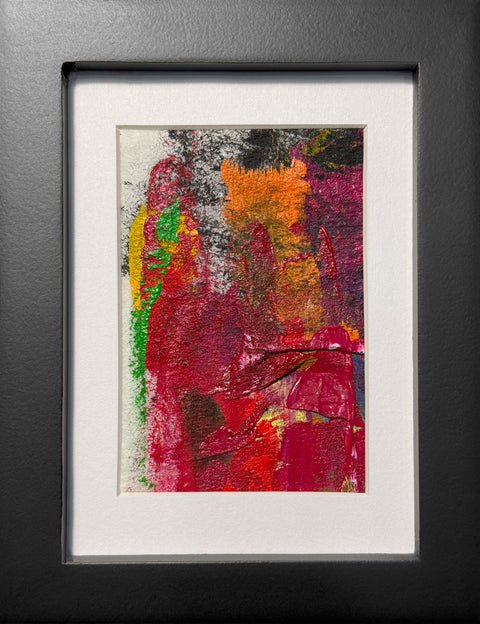 Abstract textured painting with layered brush and palette-knife strokes in bold red, magenta, green, yellow, orange, and black; matted in white and framed in black.