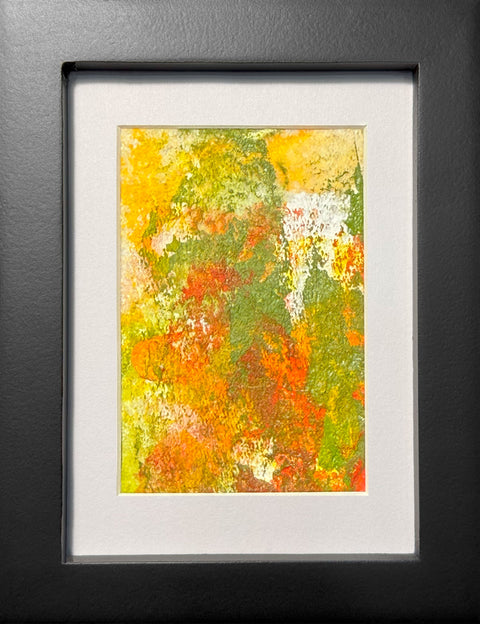 Abstract textured painting with layered brush and palette-knife strokes in orange, yellow, and green; matted in white and framed in black.