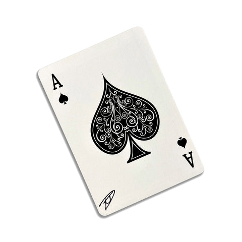 Back of the playing card showing the Ace of spaces with a hand‑signed signature ‘DJ’ in black ink.