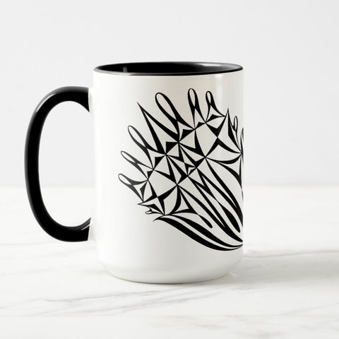 White ceramic coffee mug with a black handle and black interior, featuring a mirrored black and white print of the artwork titled “Pinned.“