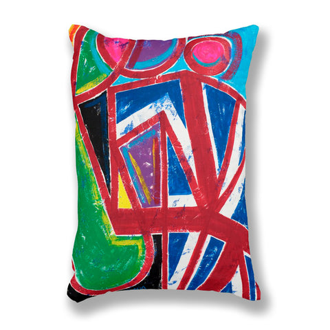 A rectangular throw pillow featuring a vibrant, abstract geometric painted pattern with bold red, blue, green, black, white, pink, and purple brushstrokes.