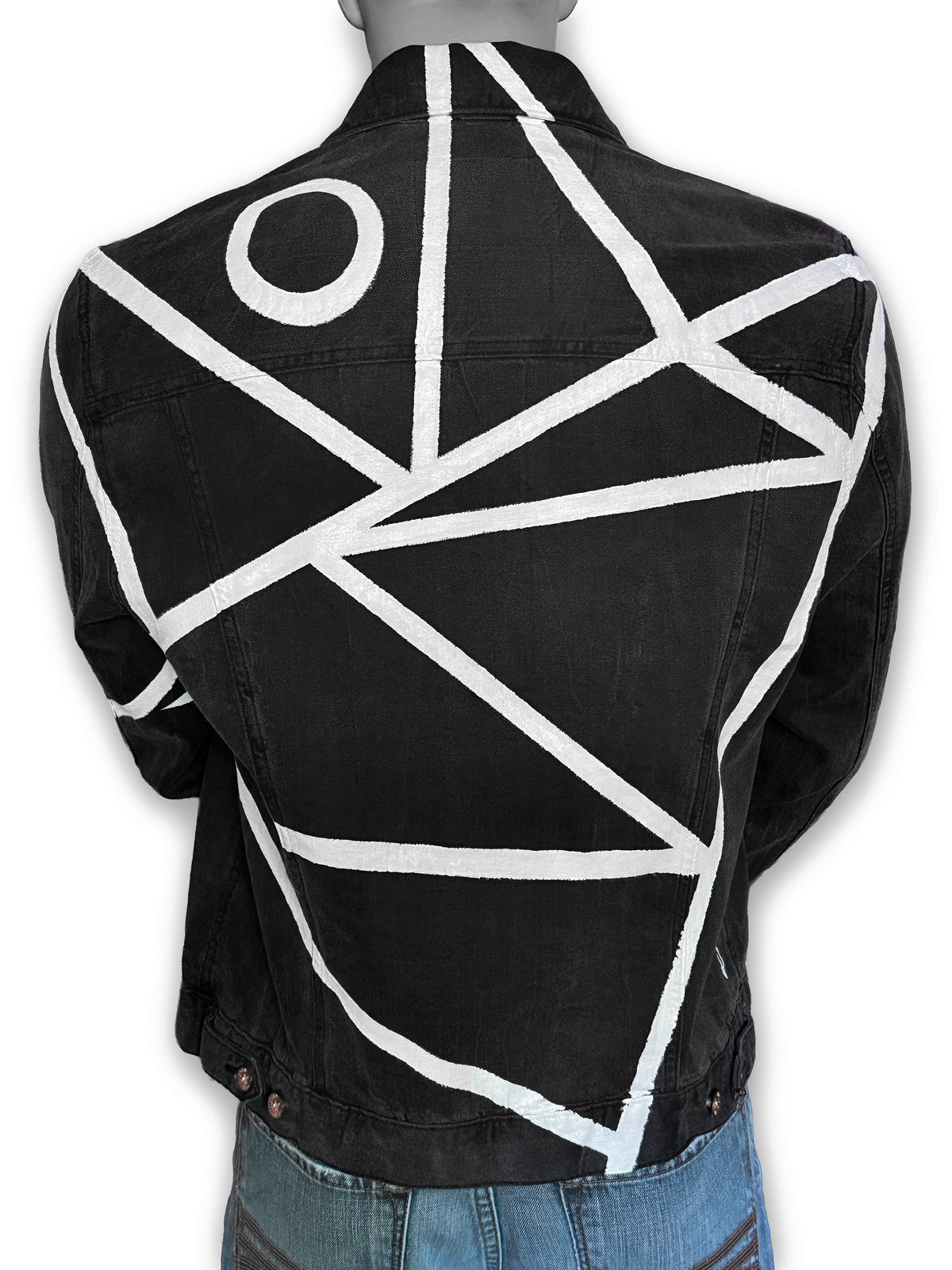 A black denim jacket with a bold white geometric line pattern and a white circle motif on the back, shown on a mannequin from the rear.