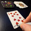 Back of the playing card showing the 10 of hearts with a hand‑signed signature ‘DJ’ in black ink.