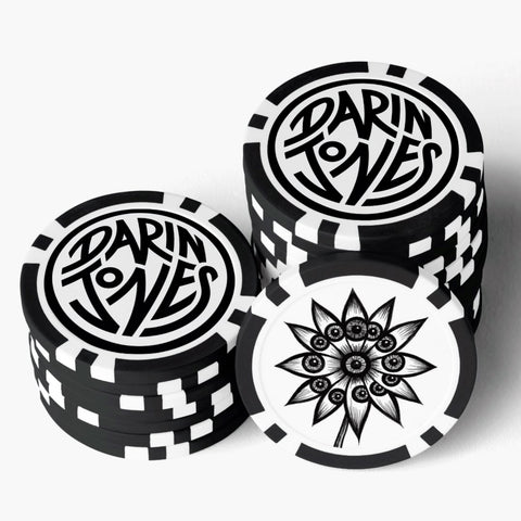Two stacks of black and white circular poker chips with the logo feauturing the  'DARIN JONES' and the artwork 'Flowerize.'