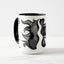 White ceramic coffee mug with a black handle and black interior, featuring a wrap‑around print of the artwork titled “Burnin’ Urchin.“