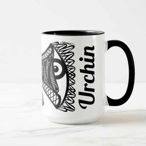 White ceramic coffee mug with a black handle and black interior, featuring a wrap‑around print of the artwork titled “Burnin’ Urchin.“
