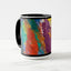 White ceramic coffee mug with a black handle and black interior, featuring a wrap‑around print of the artwork titled “Creative Palette.“