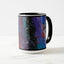 White ceramic coffee mug with a black handle and black interior, featuring a wrap‑around print of the artwork titled “Downtown Palette.“