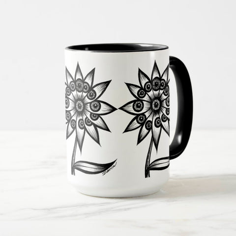 White ceramic coffee mug with a black handle and black interior, featuring a wrap‑around print of the artwork titled “Flowerize.“