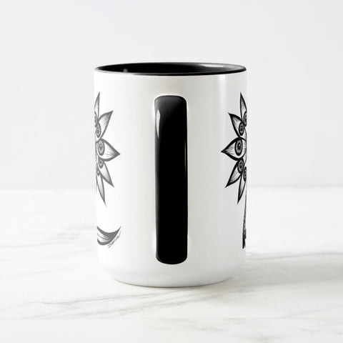 White ceramic coffee mug with a black handle and black interior, featuring a wrap‑around print of the artwork titled “Flowerize.“