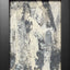 Abstract textured painting with layered brush and palette-knife strokes in shades of gray and white on a white background; framed in black.