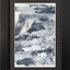 Abstract textured painting with layered brush and palette-knife strokes in shades of gray and white on a white background; matted and framed in black.