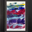 Abstract textured painting with layered brush and palette-knife strokes in blue, purple, red, teal, yellow, and white on a white background; matted and framed in black.