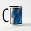 White ceramic coffee mug with a black handle and black interior, featuring a wrap‑around print of the artwork titled “Jubilation Palette.“