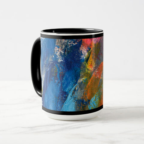 White ceramic coffee mug with a black handle and black interior, featuring a wrap‑around print of the artwork titled “Jubilation Palette.“