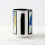 White ceramic coffee mug with a black handle and black interior, featuring a wrap‑around print of the artwork titled “Jubilation Palette.“