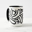 White ceramic coffee mug with a black handle and black interior, featuring a wrap‑around print of the Obscuratype™ artwork titled ‘Keith Haring.’