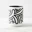 White ceramic coffee mug with a black handle and black interior, featuring a wrap‑around print of the Obscuratype™ artwork titled ‘Keith Haring.’