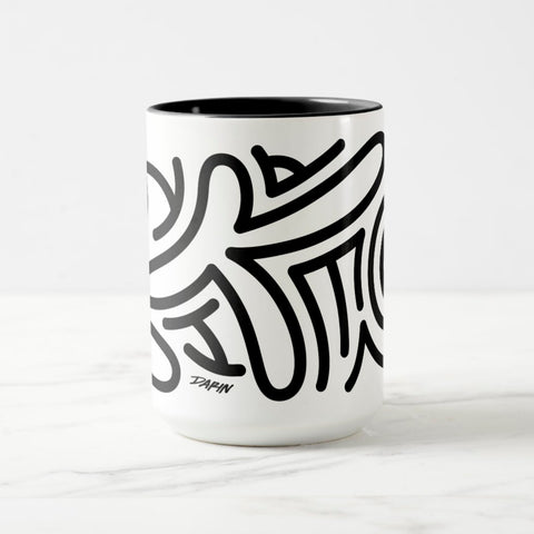 White ceramic coffee mug with a black handle and black interior, featuring a wrap‑around print of the Obscuratype™ artwork titled ‘Keith Haring.’