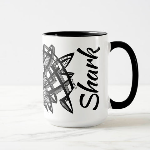 White ceramic coffee mug with a black handle and black interior, featuring a wrap‑around print of the artwork titled “Lookin’ Shark.“