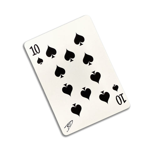 Back of the playing card showing the 10 of spades with a hand‑signed signature ‘DJ’ in black ink.