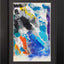 Abstract textured painting with layered brush and palette-knife strokes in blue, black, white, purple, orange, and yellow; matted and framed in black.