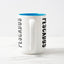 White ceramic coffee mug with a white handle and blue interior, featuring a wrap‑around print of the artwork titled “Pescados.“