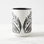 White ceramic coffee mug with a black handle and black interior, featuring a mirrored black and white print of the artwork titled “Pinned.“