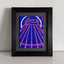 A stylized abstract painting of a tent-like structure with radiating pink lines and a white arc on a vivid blue background; signed 'DARIN' in the lower-right, mounted on a gray mat and framed in black, atop a white shelf, against a white textured wall. 