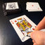 Back of the playing card showing the King of diamonds with a hand‑signed signature ‘DJ’ in black ink.