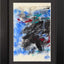 Abstract textured painting with layered brush and palette-knife strokes in black, blue, white, teal, and red on a textured off-white paper background; matted and framed in black.