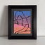 Abstract painting with a black outline of the Delicate Arch against a blue, purple, pink, and orange gradient background; signed, 'DARIN' in lower-right, mounted on a gray mat, framed in black, atop a white shelf and against a textured white wall.