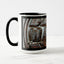 A white ceramic coffee mug with a black handle and black interior, featuring the ‘WA’ section of a wrap-around photographic print of a wet street plate with the word ‘WATER’. 