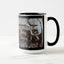 A white ceramic coffee mug with a black handle and black interior, featuring the ‘ER’ section of a wrap-around photographic print of a wet street plate with the word ‘WATER’. 